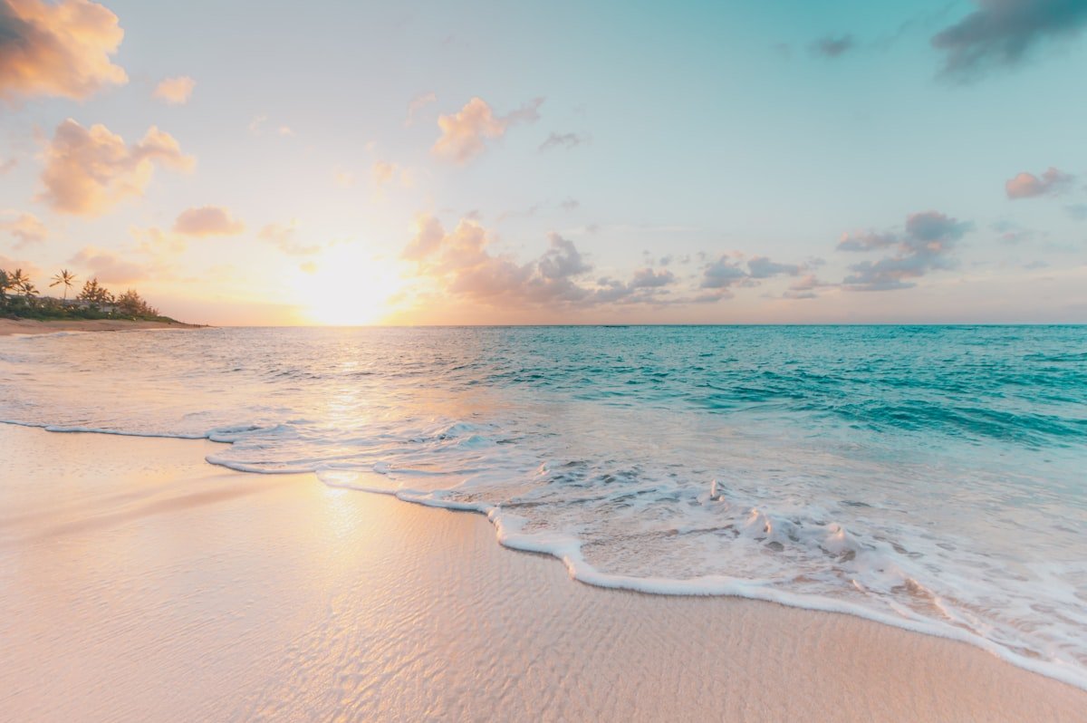 Tropical beach at sunset — while you enjoy your vacation, your house may be broadcasting that nobody is home